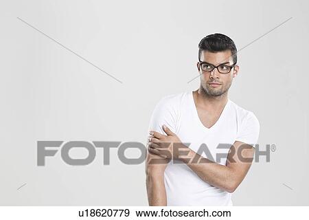 Stock Photo - Curious man holding arm. Fotosearch