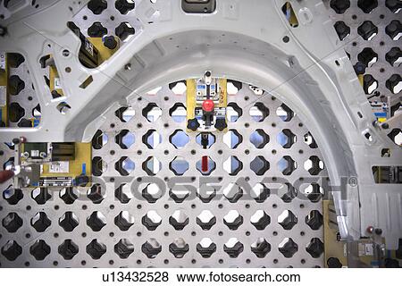 Stock Photo - Detail of car part on measuring machine in car factory. Fotosearch