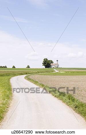 Stock Image - Dirt road in rural landscape. Fotosearch