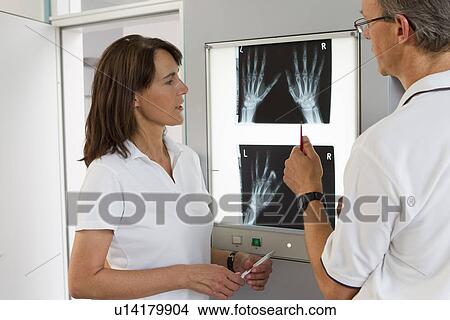 Picture - Doctor and nurse examining x-rays. Fotosearch