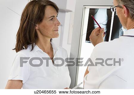 Doctor and nurse examining x-rays View Large Photo Image Stock Photography - Doctor and nurse examining x-rays. Fotosearch