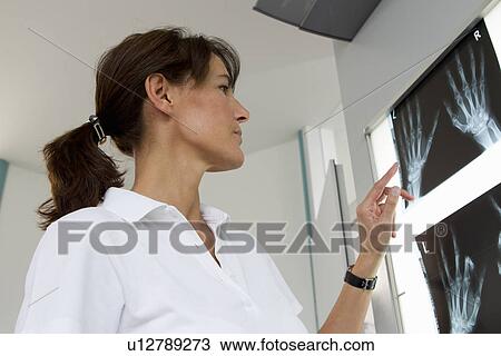 Doctor examining x-rays of hands View Large Photo Image Stock Image - Doctor examining x-rays of hands. Fotosearch