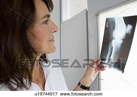 Doctor examining x-rays View Large Photo Image Stock Photo - Doctor examining x-rays. Fotosearch