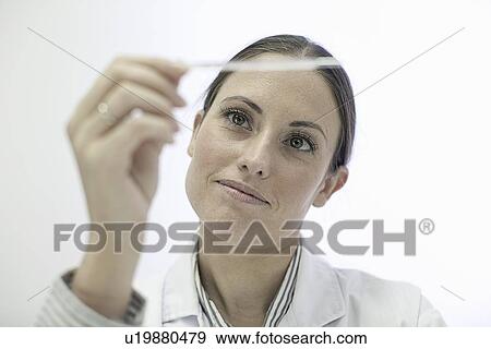 Doctor reading test strip View Large Photo Image Stock Photo - Doctor reading test strip. Fotosearch