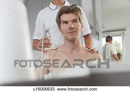 Doctor using sonogram on patient View Large Photo Image Stock Image - Doctor using sonogram on patient. Fotosearch