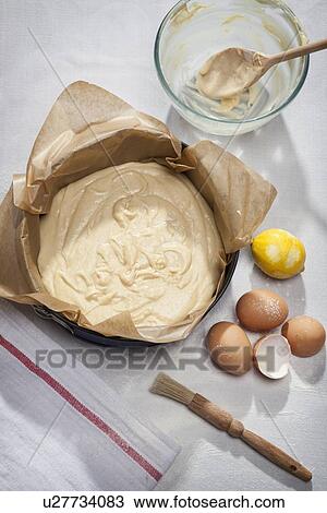 Stock Image - Eggshells, flour, lemon and batter. Fotosearch