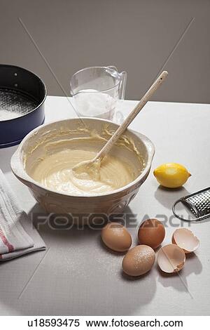 Stock Photography - Eggshells, flour, lemon and batter. Fotosearch