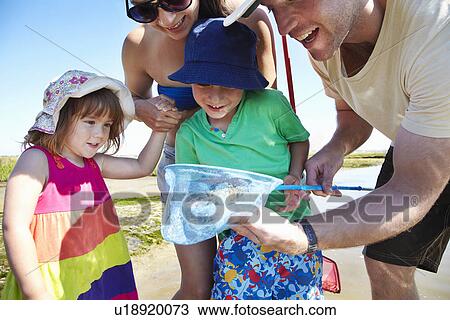 Family fishing with nets outdoors View Large Photo Image Stock Image - Family fishing with nets outdoors. Fotosearch