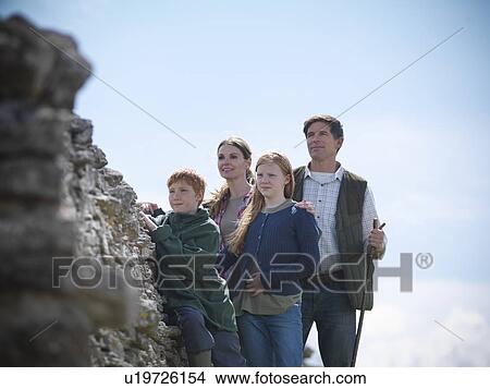 Farmer and family standing by stone wall View Large Photo Image Picture - Farmer and family standing by stone wall. Fotosearch