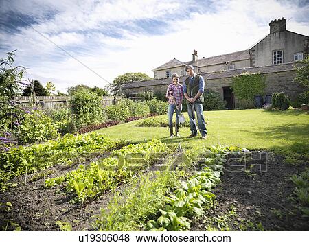 Stock Photo - Farmer and wife working in garden. Fotosearch