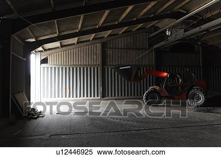 Farmer driving digger in shed View Large Photo Image Stock Photography - Farmer driving digger in shed. Fotosearch
