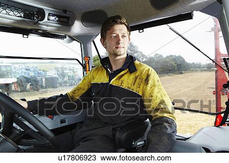 Farmer driving tractor in field View Large Photo Image Stock Image - Farmer driving tractor in field. Fotosearch