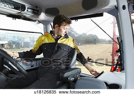 Farmer driving tractor in field View Large Photo Image Stock Photography - Farmer driving tractor in field. Fotosearch