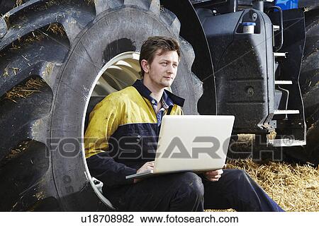 Farmer using laptop in field View Large Photo Image Stock Image - Farmer using laptop in field. Fotosearch