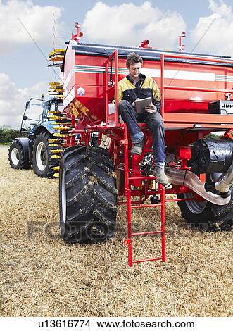 Farmer using tablet computer outdoors View Large Photo Image Picture - Farmer using tablet computer outdoors. Fotosearch