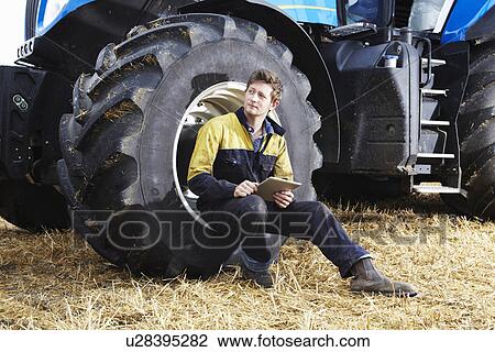 Farmer using tablet computer outdoors View Large Photo Image Stock Image - Farmer using tablet computer outdoors. Fotosearch