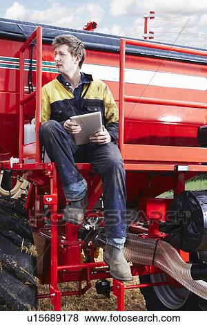 Farmer using tablet computer outdoors View Large Photo Image Stock Photo - Farmer using tablet computer outdoors. Fotosearch