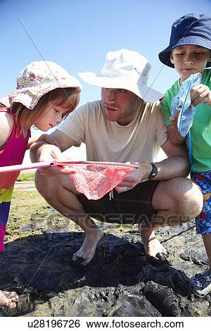 Father and children fishing with nets View Large Photo Image Stock Photograph - Father and children fishing with nets. Fotosearch
