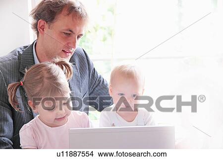Father and children playing with laptop View Large Photo Image Picture - Father and children playing with laptop. Fotosearch
