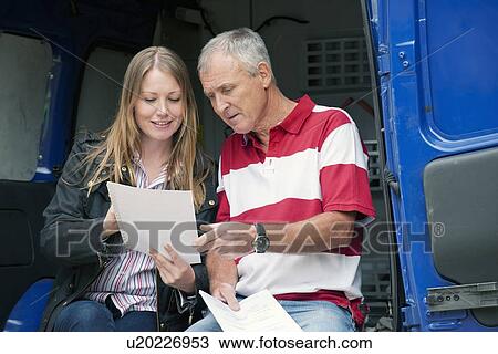 Father and daughter examining papers View Large Photo Image Stock Image - Father and daughter examining papers. Fotosearch