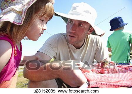 Father and daughter fishing with nets View Large Photo Image Stock Photography - Father and daughter fishing with nets. Fotosearch