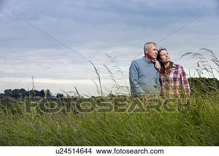 Picture - Father and daughter in tall grass. Fotosearch