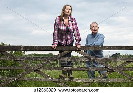 Father and daughter on wooden fence View Large Photo Image Stock Photo - Father and daughter on wooden fence. Fotosearch