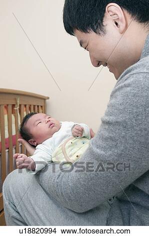 Father holding sleeping baby View Large Photo Image Picture - Father holding sleeping baby. Fotosearch