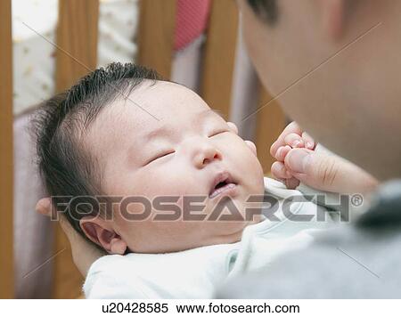 Father holding sleeping baby View Large Photo Image Stock Photography - Father holding sleeping baby. Fotosearch