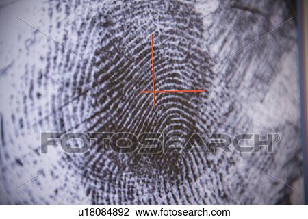 Stock Image - Fingerprint on screen in forensic lab. Fotosearch