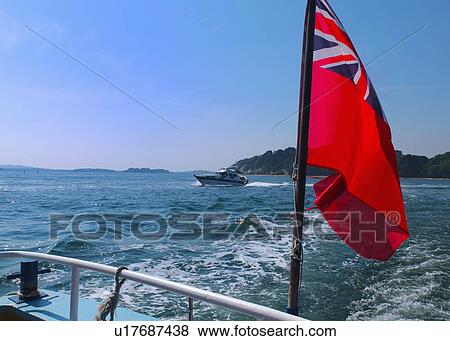 Stock Photo - Flag waving from boat on water. Fotosearch