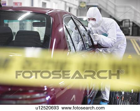 Stock Image - Forensic scientist at crime scene. Fotosearch