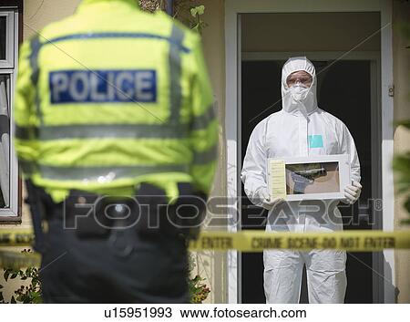 Stock Image - Forensic scientist at crime scene. Fotosearch