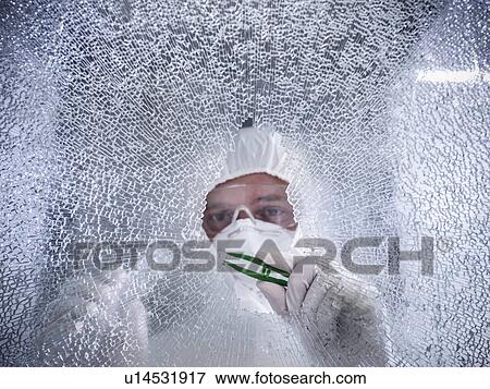 Stock Photo - Forensic scientist at shattered window. Fotosearch