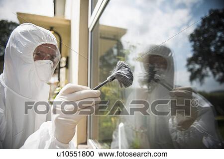 Stock Image - Forensic scientist dusting window. Fotosearch