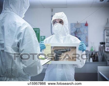 Forensic scientist with gun in box View Large Photo Image Stock Photograph - Forensic scientist with gun in box. Fotosearch