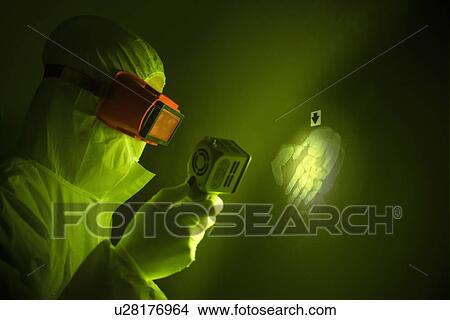 Picture - Forensic scientist with handprint. Fotosearch