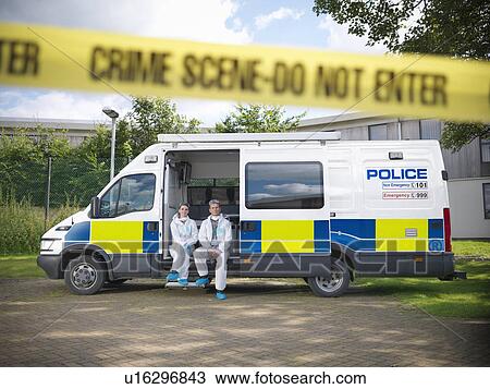 Stock Image - Forensic scientists at crime scene. Fotosearch