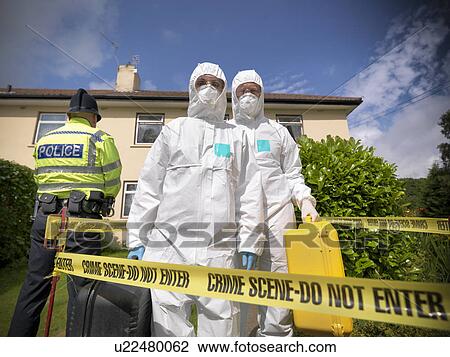Stock Image - Forensic scientists at crime scene. Fotosearch