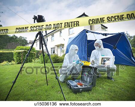 Stock Photograph - Forensic scientists at crime scene. Fotosearch