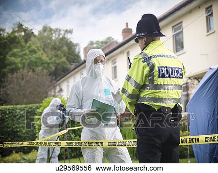 Stock Photograph - Forensic scientists at crime scene. Fotosearch