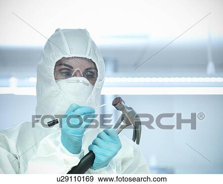 Stock Photo - Forensic student examining bloody hammer. Fotosearch