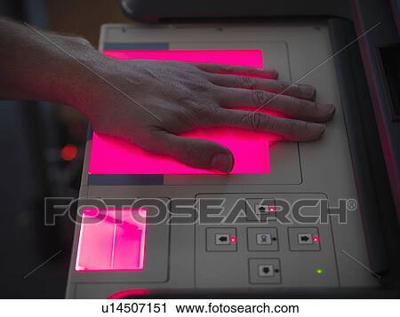 Stock Image - Forensic student taking fingerprints. Fotosearch