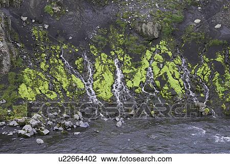 Stock Image - Frozen streams on rocky hillside. Fotosearch