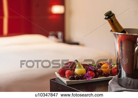 Fruit plate and champagne in hotel room View Large Photo Image Stock Photo - Fruit plate and champagne in hotel room. Fotosearch