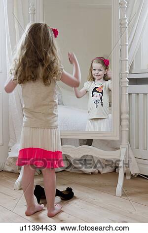 Girl admiring herself in mirror View Large Photo Image Stock Image - Girl admiring herself in mirror. Fotosearch