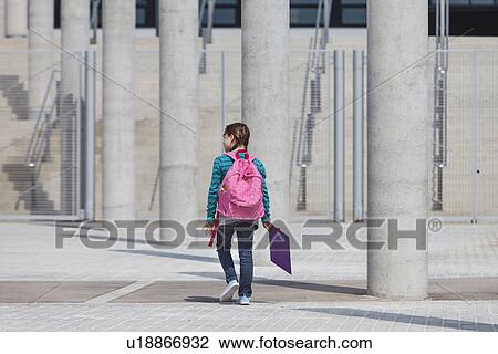Girl carrying folder in courtyard View Large Photo Image Stock Image - Girl carrying folder in courtyard. Fotosearch