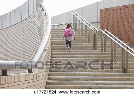 Picture - Girl climbing steps outdoors. Fotosearch