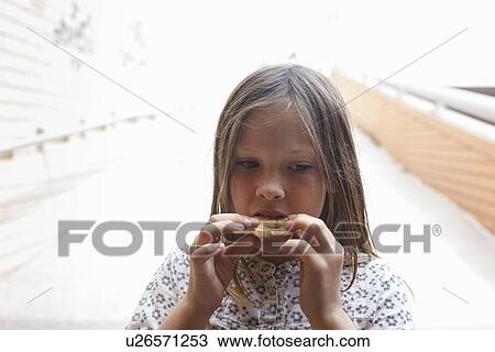 Girl eating cookie outdoors View Large Photo Image Stock Image - Girl eating cookie outdoors. Fotosearch