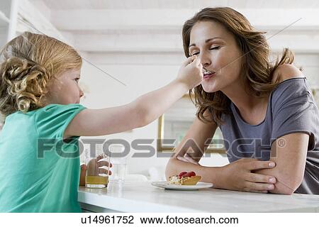 Girl feeding mother breakfast View Large Photo Image Stock Image - Girl feeding mother breakfast. Fotosearch